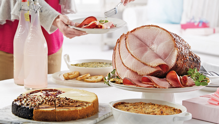 HoneyBaked sliced ham table spread with sides and dessert