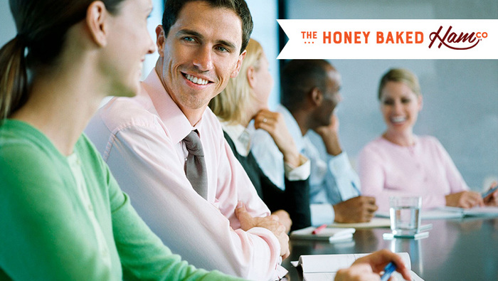 Group business meeting with The Honey Baked Ham Co.® logo