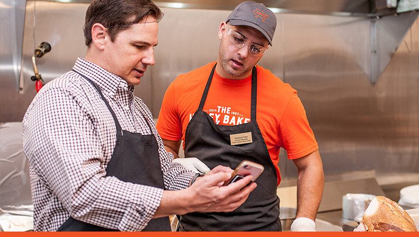 Franchise Business Leader assisting store staff