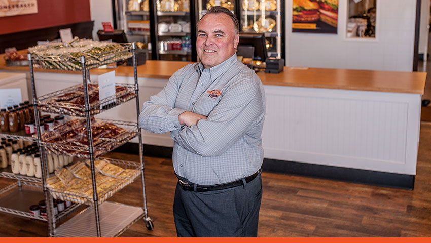 HoneyBaked Ham Franchisee standing in his store