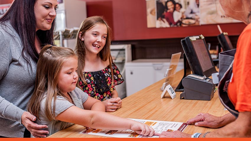 Customers at HoneyBaked counter