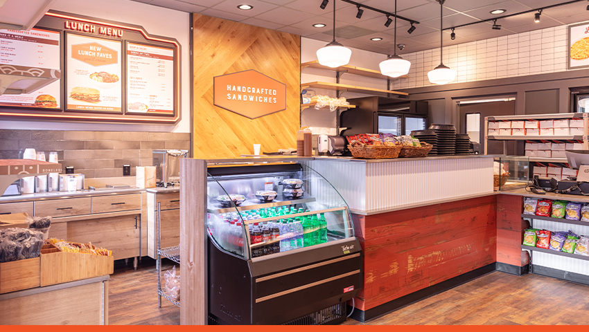 Interior of a HoneyBaked storefront with display cases and a check out counter.